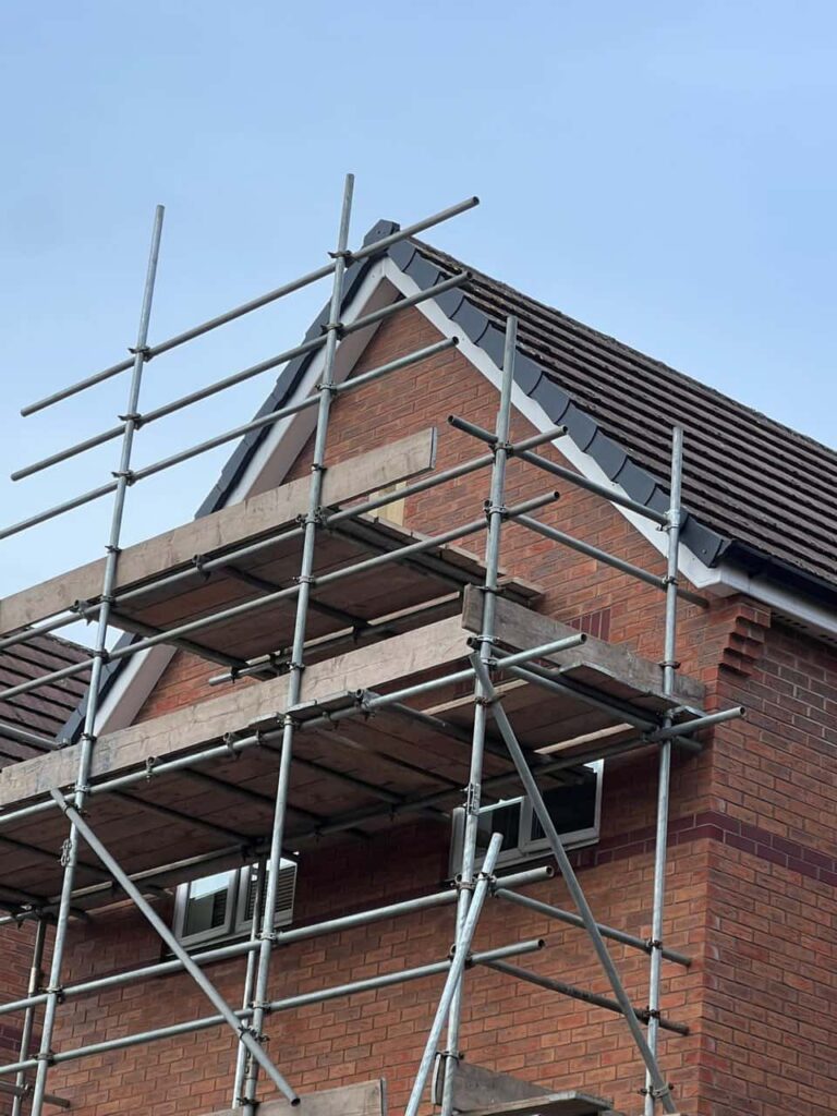 This is a photo of a roof which has just been repaired. There is a scaffold located at the gable end for access onto the roof. Works carried out by LJ Roofing Wroughton